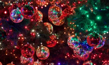 Stock photo close up of Christmas lights reflected in ornaments