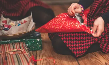 Image of someone opening presents 