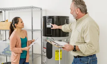 Contractor showing a customer a Heat Pump Water Heater (HPWH)