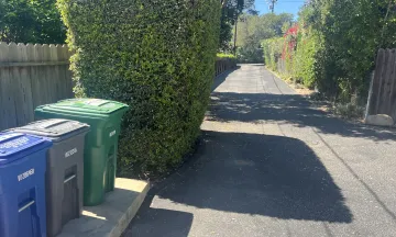 MarBorg recycling, trash, and yard waste containers on a private property