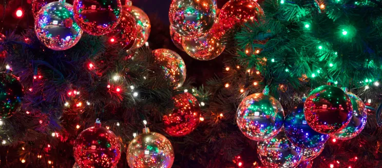 Stock photo close up of Christmas lights reflected in ornaments