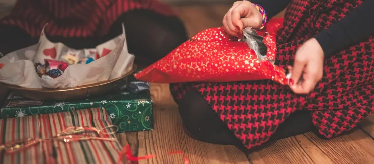 Image of someone opening presents 