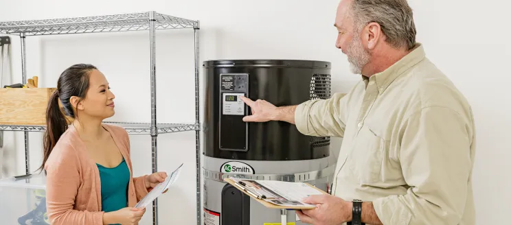 Contractor showing a customer a Heat Pump Water Heater (HPWH)