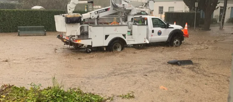 A City of Santa Barbara truck drives through flooded City streets during a January 2023 storm.
