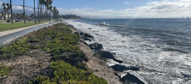 View of East Beach with high tide eroding beach and reaching iceplant along bike path