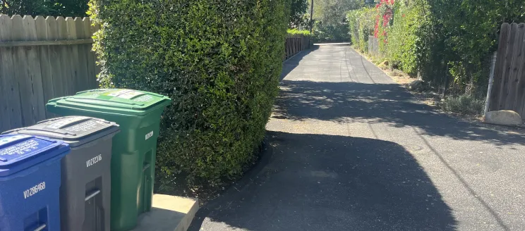 MarBorg recycling, trash, and yard waste containers on a private property