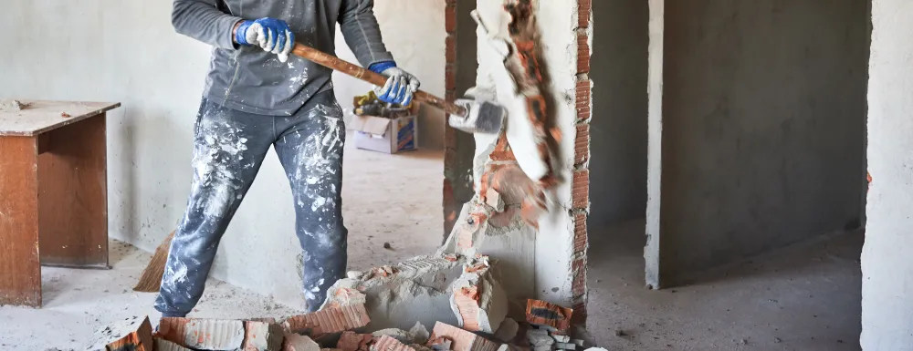 Man with sledgehammer demolition 