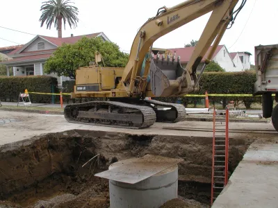 Heavy equipment in street installing Haley Street CDS (continuous deflection system) unit