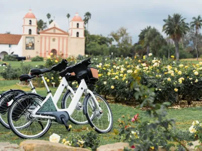 Two electric-assist bicycles at the Rose Garden at the Santa Barbara Mission. 