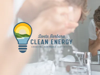 Man washing his face in bathroom sink with a reflection in the mirror, and the Santa Barbara Clean Energy logo