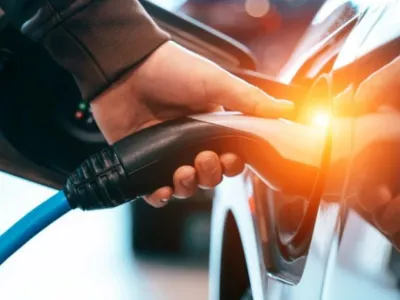 Image of a charger being plugged into an electric vehicle